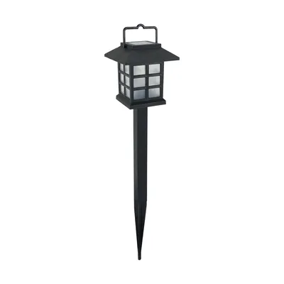 Czarna lampa solarna LED DONA z panelem słonecznym na górze i ozdobnymi, białymi szybkami, osadzona na szpikulcu do wbijania w ziemię.